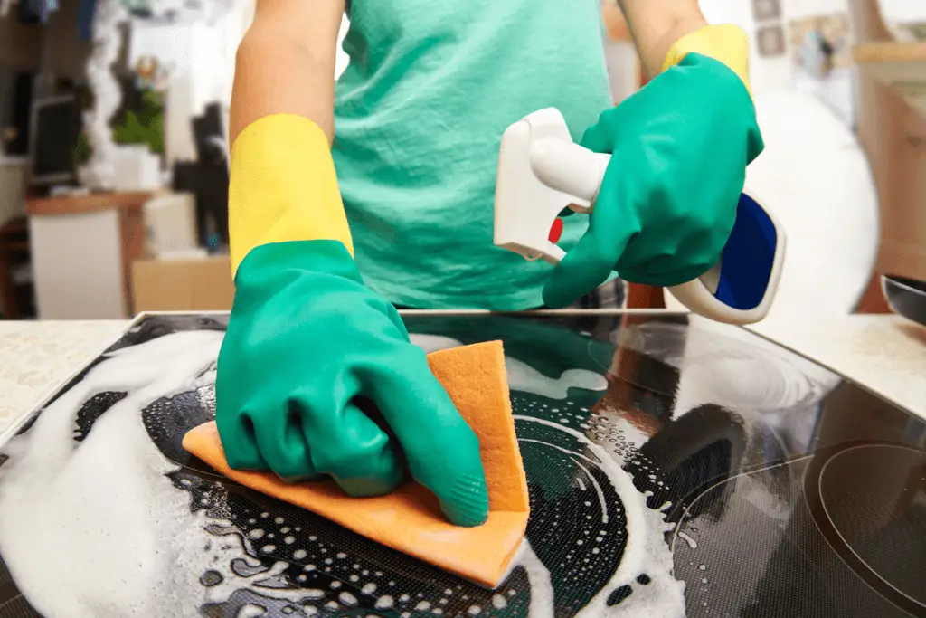 a person cleaning a stove