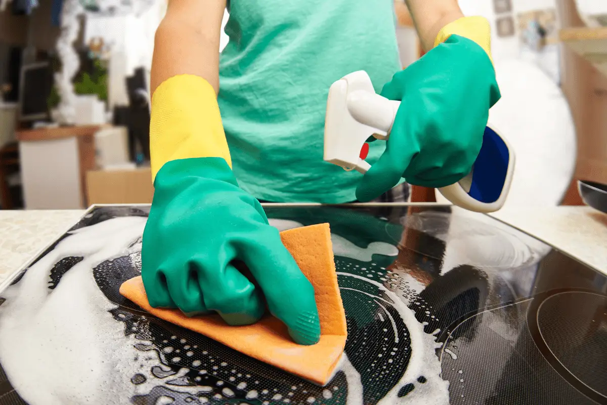 a person cleaning a stove