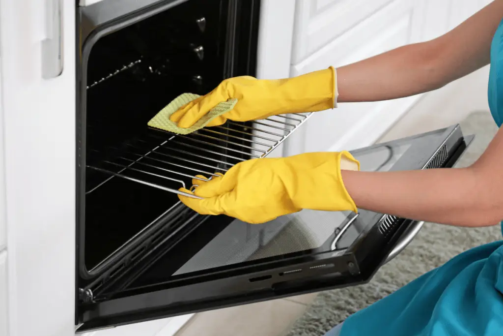 a person cleaning a oven