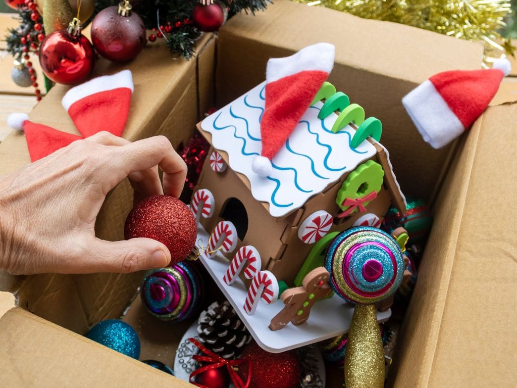 a hand holding a red ball in a box