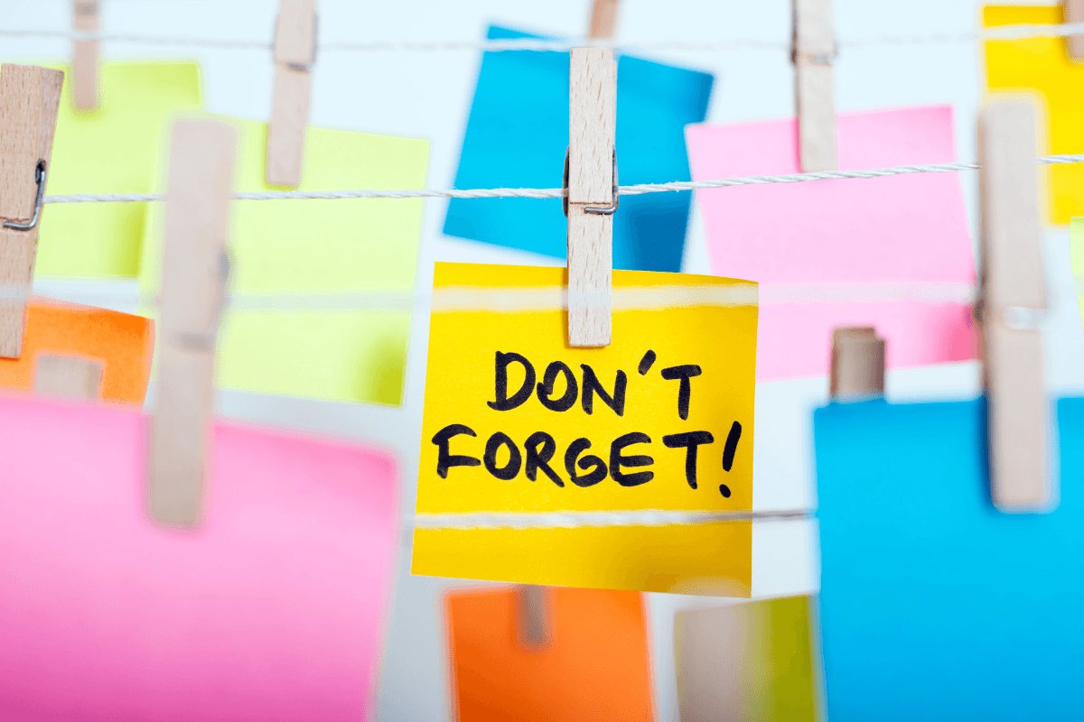 a group of colorful paper notes attached to a rope with clothespins
