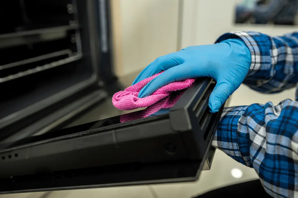 a person cleaning a microwave