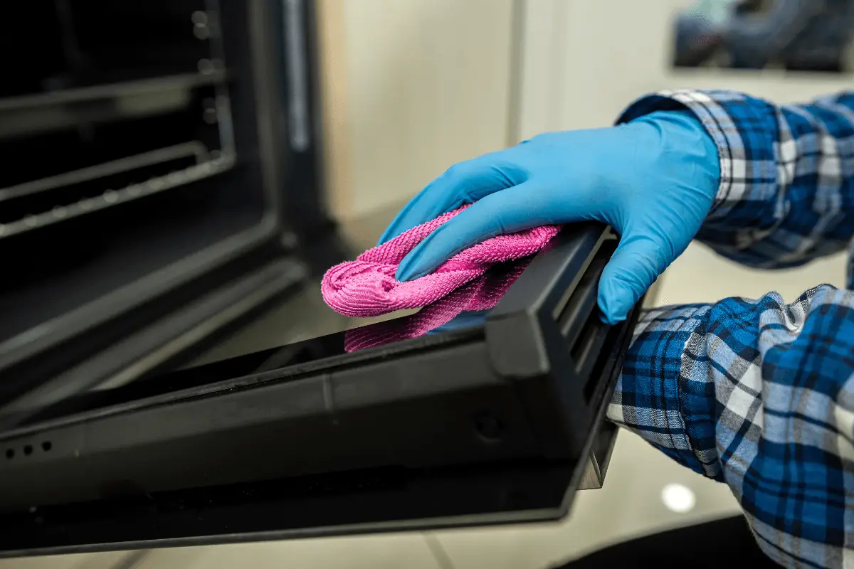 a person cleaning a microwave