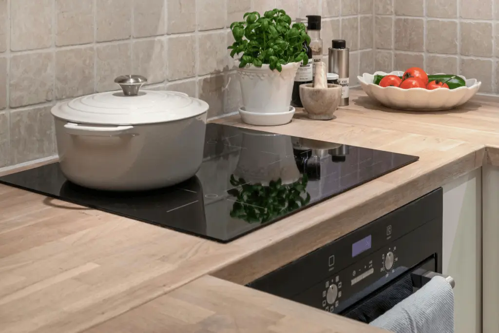 a kitchen counter with a pot and a bowl of vegetables