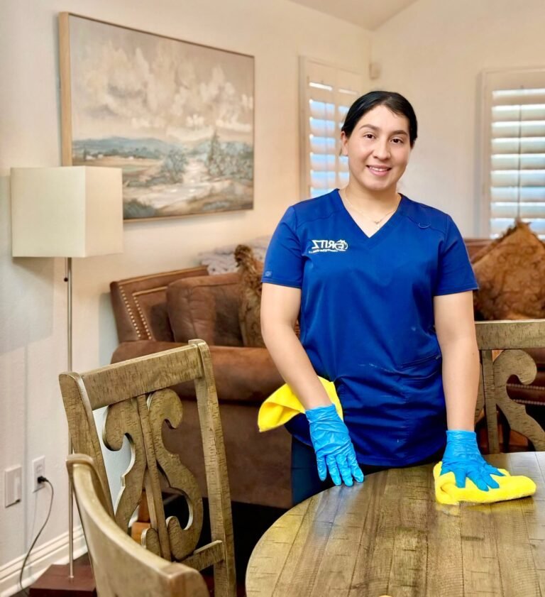 Yari, owner of Gritz Cleaning, wiping a dining table in a client's home