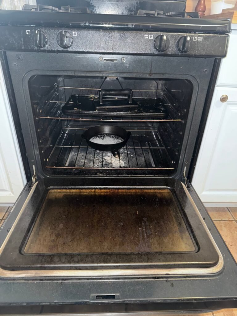 Oven with grease and burnt residue before cleaning