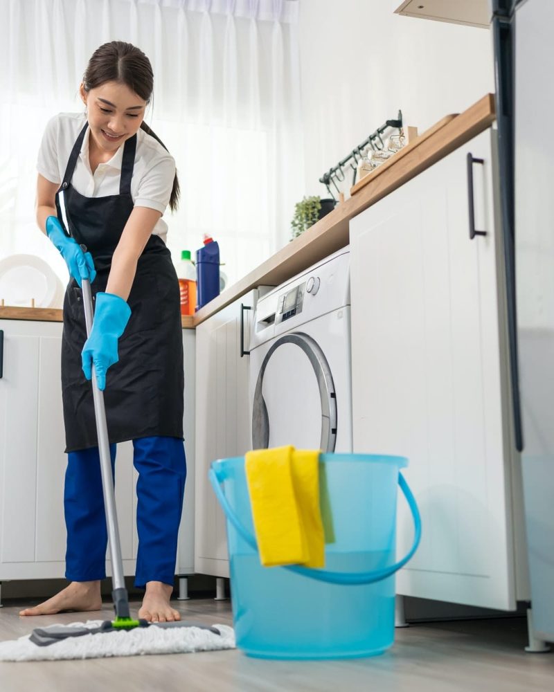 a woman mopping the floor