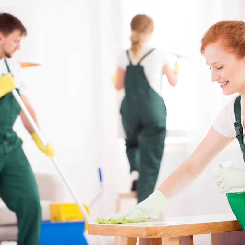 a woman cleaning a table