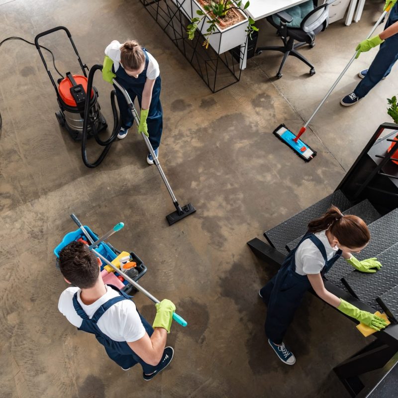 a group of people cleaning in an office
